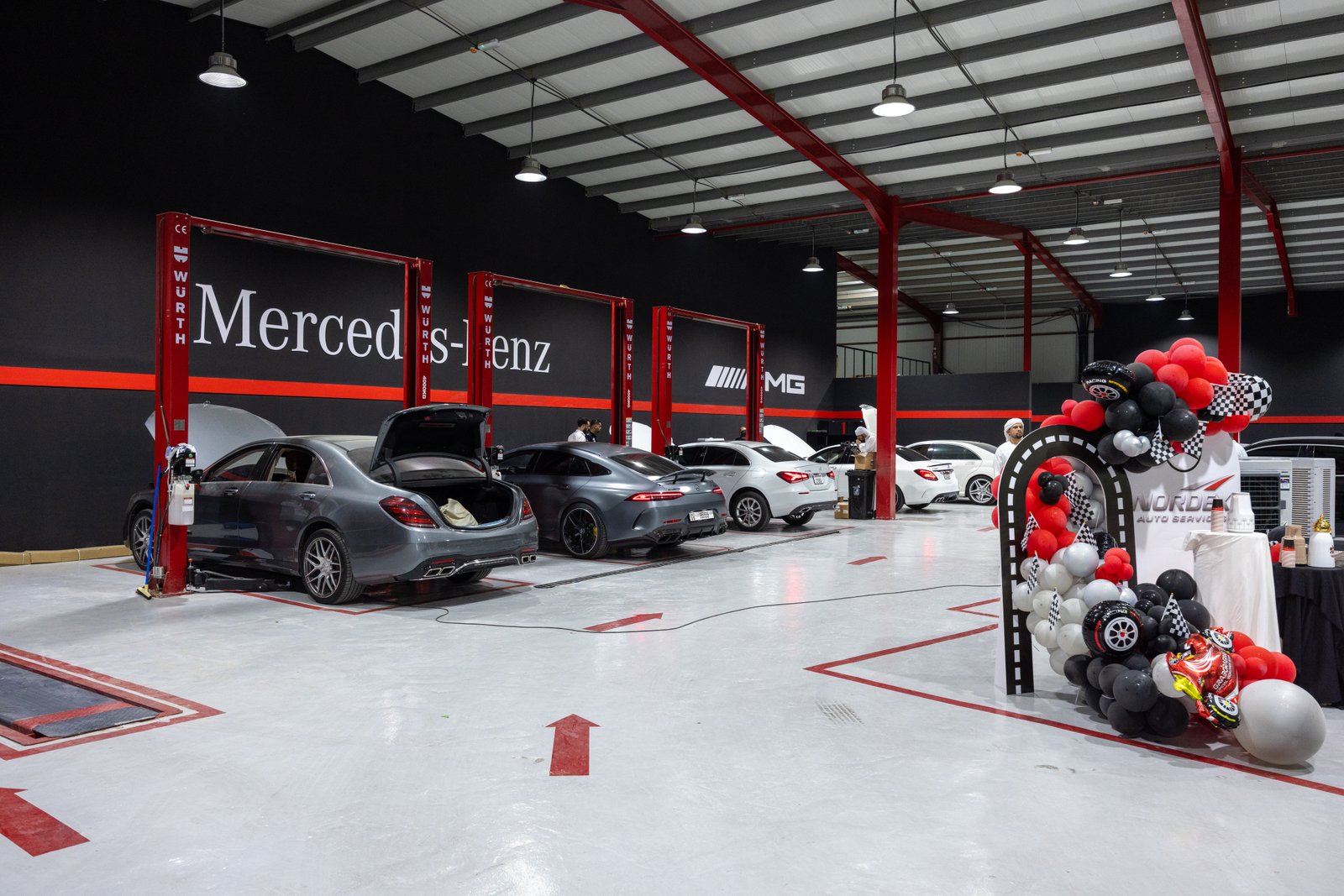 Nordex Autoservices workshop — multiple Mercedes vehicles on service lifts